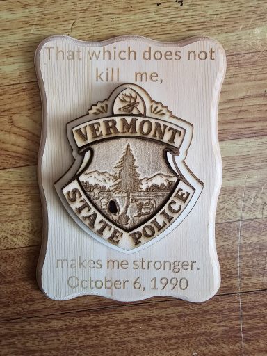 Vermont State Police badge with the quote "That which does not kill me makes me stronger."