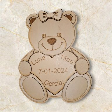 Wooden teddy bear holding a heart, engraved with the name "Luna Mae" and the date "7-01-2022."