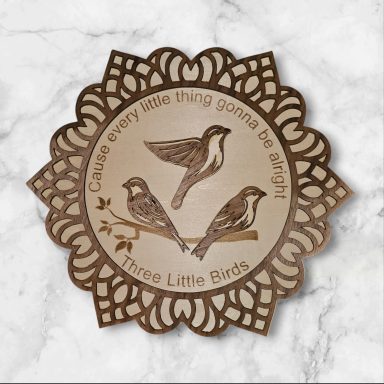 Three small birds on a decorative circular plaque with an inspirational quote.